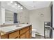 Bathroom featuring wood cabinets, laminate counters, and washer and dryer in view at 433 Sellers Pl, Henderson, NV 89011