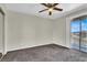 Bedroom with a ceiling fan, carpet, and a sliding glass door that leads to a patio at 433 Sellers Pl, Henderson, NV 89011