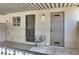A covered patio featuring an entry door with storm door and storage area, and a small window at 433 Sellers Pl, Henderson, NV 89011