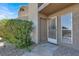 A tan two-story condo with gravel landscaping and a small decorative bush at the front door entrance at 433 Sellers Pl, Henderson, NV 89011