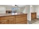 A kitchen and bathroom area with open layout including wood cabinets and tile floors at 433 Sellers Pl, Henderson, NV 89011