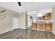 Open-concept living room with wood flooring, breakfast bar, and access to the staircase at 433 Sellers Pl, Henderson, NV 89011