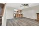 Open-concept living room with wood flooring, fireplace, breakfast bar, and access to the staircase at 433 Sellers Pl, Henderson, NV 89011