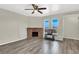 Bright living room with a brick fireplace, wood floors, and bright natural light at 433 Sellers Pl, Henderson, NV 89011