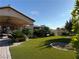 Beautiful backyard featuring artificial turf, and a covered patio at 4455 W Ford Ave, Las Vegas, NV 89139