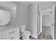 Bathroom featuring a modern vanity, toilet, shower, and a view into the bedroom at 4455 W Ford Ave, Las Vegas, NV 89139