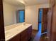 Bathroom with a double sink vanity, white countertops, and a large mirror at 4455 W Ford Ave, Las Vegas, NV 89139