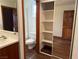 Bathroom with a walk-in shower and a closet with mirrored sliding doors and shelves at 4455 W Ford Ave, Las Vegas, NV 89139