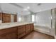 Primary bath showcasing dual sinks, soaking tub, and separate shower with glass door at 4455 W Ford Ave, Las Vegas, NV 89139