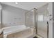 Elegant bathroom features a corner soaking tub and walk-in shower with glass door at 4455 W Ford Ave, Las Vegas, NV 89139