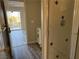 Bathroom featuring tiled shower stall and grey wood-look floors, as viewed from doorway at 4455 W Ford Ave, Las Vegas, NV 89139