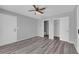 Bedroom features gray walls, wood floors, ceiling fan and closets at 4455 W Ford Ave, Las Vegas, NV 89139