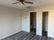 Bedroom with grey wood-look floors, closet with bi-fold doors, and ensuite bathroom at 4455 W Ford Ave, Las Vegas, NV 89139