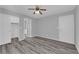 Bright bedroom with gray walls, wood-look flooring, a ceiling fan, and ensuite bathroom at 4455 W Ford Ave, Las Vegas, NV 89139