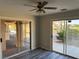 Bedroom featuring sliding glass doors to patio, ceiling fan, and grey wood-look floors at 4455 W Ford Ave, Las Vegas, NV 89139