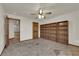 The bedroom features a ceiling fan, tile flooring, built-in shelves, and a doorway view to other rooms at 4455 W Ford Ave, Las Vegas, NV 89139