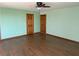 Bedroom featuring laminate flooring, ceiling fan, and wood doors at 4455 W Ford Ave, Las Vegas, NV 89139