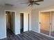 Bedroom features sliding glass door, and closet with bi-fold doors, and grey wood-look floors at 4455 W Ford Ave, Las Vegas, NV 89139