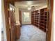 Bedroom featuring built-in bookcase, tile floors, and neutral color palette at 4455 W Ford Ave, Las Vegas, NV 89139