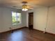 Bright bedroom featuring wood floors, closet, and a window overlooking lush greenery at 4455 W Ford Ave, Las Vegas, NV 89139