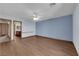 The spacious bedroom has wood floors and ceiling fan, with an adjoining bathroom view at 4455 W Ford Ave, Las Vegas, NV 89139