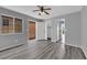 Spacious bedroom featuring wood-look floors, gray walls, and abundant natural light through a window at 4455 W Ford Ave, Las Vegas, NV 89139