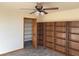 Bedroom featuring tile floor, ceiling fan, built-in bookcase and walk-in closet at 4455 W Ford Ave, Las Vegas, NV 89139