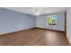 Bright bedroom featuring hardwood floors, a ceiling fan, and a window providing ample natural light at 4455 W Ford Ave, Las Vegas, NV 89139