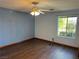 Bedroom with a ceiling fan, wood floors, and a window at 4455 W Ford Ave, Las Vegas, NV 89139