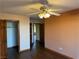 Spacious bedroom featuring a ceiling fan, wood floors, and a closet with a wooden door at 4455 W Ford Ave, Las Vegas, NV 89139