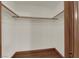 Walk-in closet with hardwood flooring and white shelving for easy organization and storage at 4455 W Ford Ave, Las Vegas, NV 89139