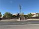 Wide angle shot of a single story home with a decorative windmill and desert landscaping behind a brick fence at 4455 W Ford Ave, Las Vegas, NV 89139