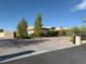 Single story home featuring desert landscaping with a circular driveway and a brick perimeter fence at 4455 W Ford Ave, Las Vegas, NV 89139
