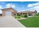 Charming home featuring desert landscaping, an expansive driveway, a garage, and a covered patio at 4455 W Ford Ave, Las Vegas, NV 89139