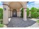 Covered front porch with stone pillars and gated entry to the courtyard at 4455 W Ford Ave, Las Vegas, NV 89139