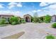 Attractive desert landscaping and a brick driveway enhance this home's curb appeal at 4455 W Ford Ave, Las Vegas, NV 89139