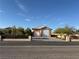 Attached garage with brick driveway, decorative fence, and desert landscaping at 4455 W Ford Ave, Las Vegas, NV 89139