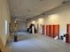 Spacious garage featuring a roll up door, shelving, and windows at 4455 W Ford Ave, Las Vegas, NV 89139