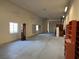 Large open garage space with fluorescent lights, storage shelving, and windows at 4455 W Ford Ave, Las Vegas, NV 89139