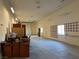 Expansive garage space with ample room, a roll-up door, and bright overhead lighting, offering versatility and functionality at 4455 W Ford Ave, Las Vegas, NV 89139