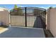 View of an iron gate and concrete walkway on a clear day at 4455 W Ford Ave, Las Vegas, NV 89139