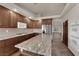 Spacious kitchen features wood cabinets, granite countertops and stainless steel appliances at 4455 W Ford Ave, Las Vegas, NV 89139