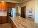 Modern kitchen featuring granite countertops, stainless steel appliances, and ample cabinet space at 4455 W Ford Ave, Las Vegas, NV 89139