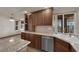 The kitchen features granite countertops, wood cabinets, tile floors and stainless steel appliances at 4455 W Ford Ave, Las Vegas, NV 89139
