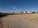 Cleared lot with a retaining wall, offering potential for new construction with utilities and neighborhood views at 4455 W Ford Ave, Las Vegas, NV 89139