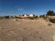 Vacant land featuring a pre-built retaining wall, offering a clean slate for development within a residential area at 4455 W Ford Ave, Las Vegas, NV 89139