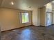 Well-lit living room with large windows and neutral paint colors, featuring tile flooring at 4455 W Ford Ave, Las Vegas, NV 89139