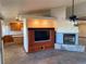 Open-concept living area with a built-in entertainment center and a cozy fireplace at 4455 W Ford Ave, Las Vegas, NV 89139
