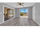 Living room with wood floors, ceiling fan, and a sliding glass door to the outside at 4455 W Ford Ave, Las Vegas, NV 89139