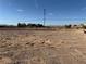 A flat vacant lot ready for building with a concrete block perimeter and mountain views at 4455 W Ford Ave, Las Vegas, NV 89139